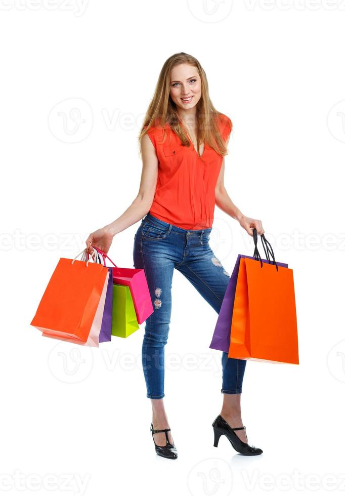 Happy lovely woman with shopping bags over white photo