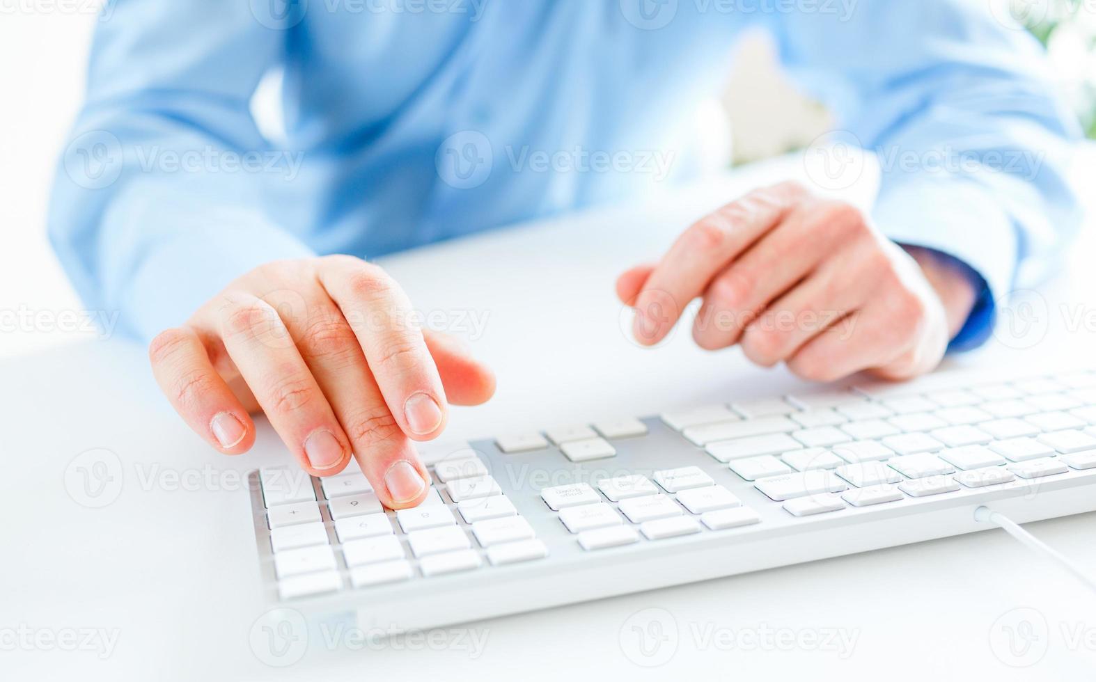 Men office worker typing on the keyboard photo