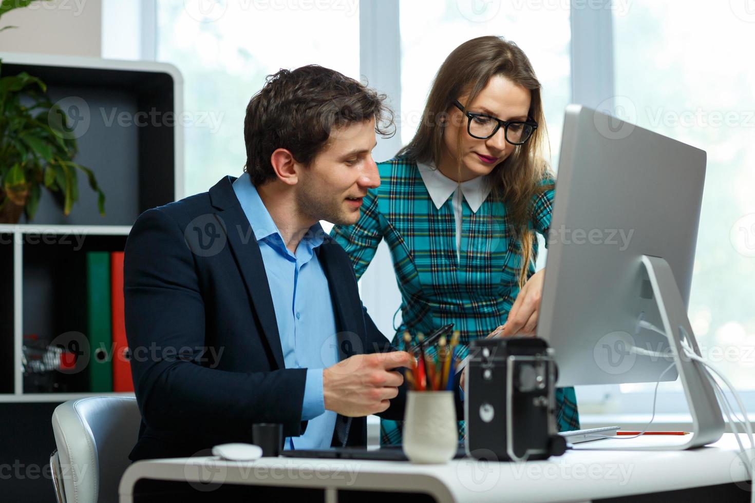 Young colleague - man and woman working from home - modern business concept photo