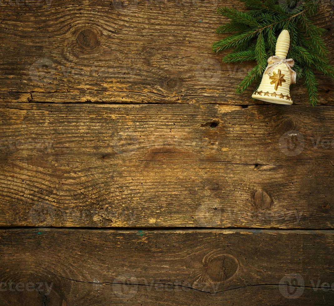 Christmas tree branches with christmas decorations on wooden texture ready for your design photo