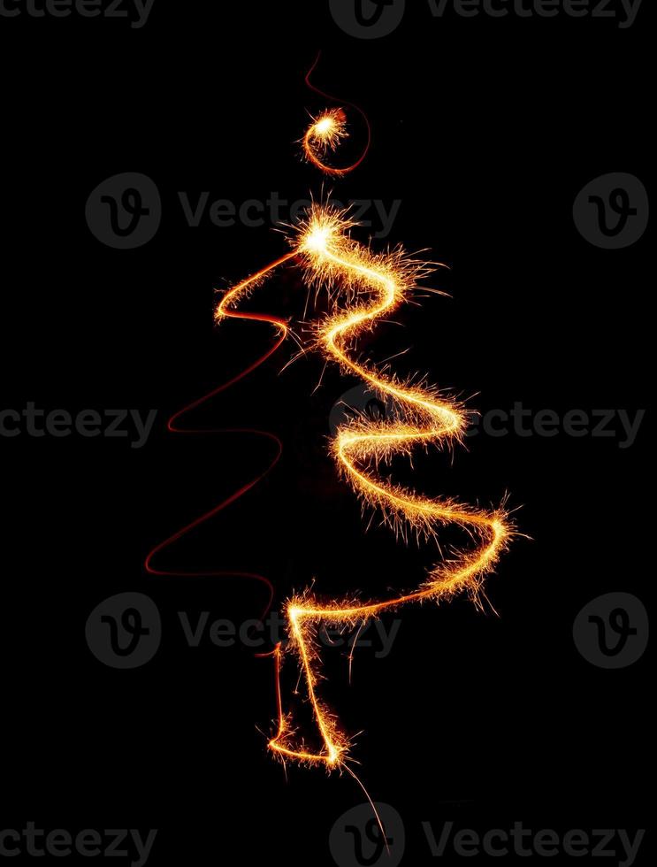 Christmas tree made by sparkler on a black photo