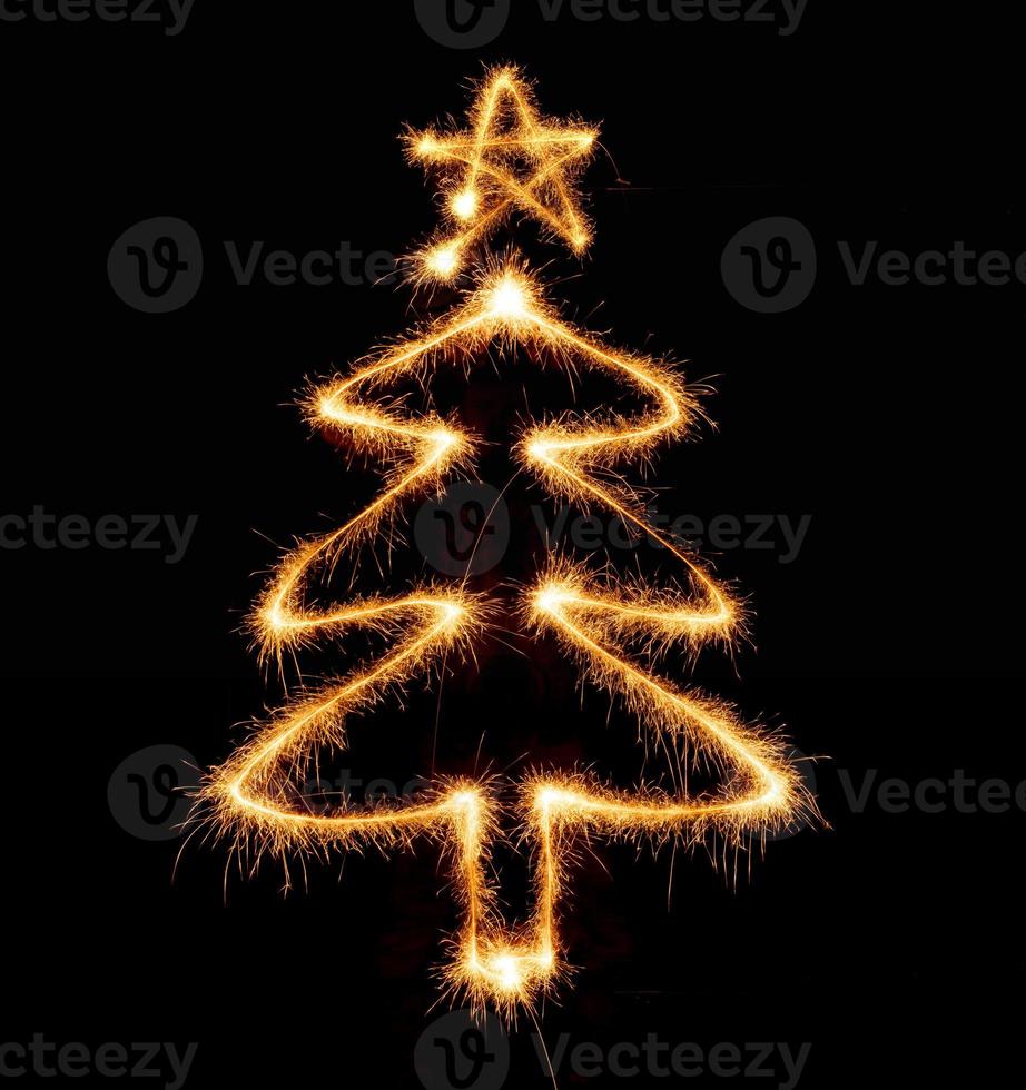 Christmas tree made by sparkler on a black photo