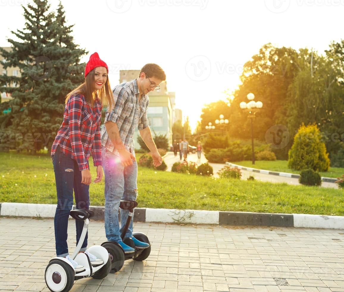 Young couple riding hoverboard photo