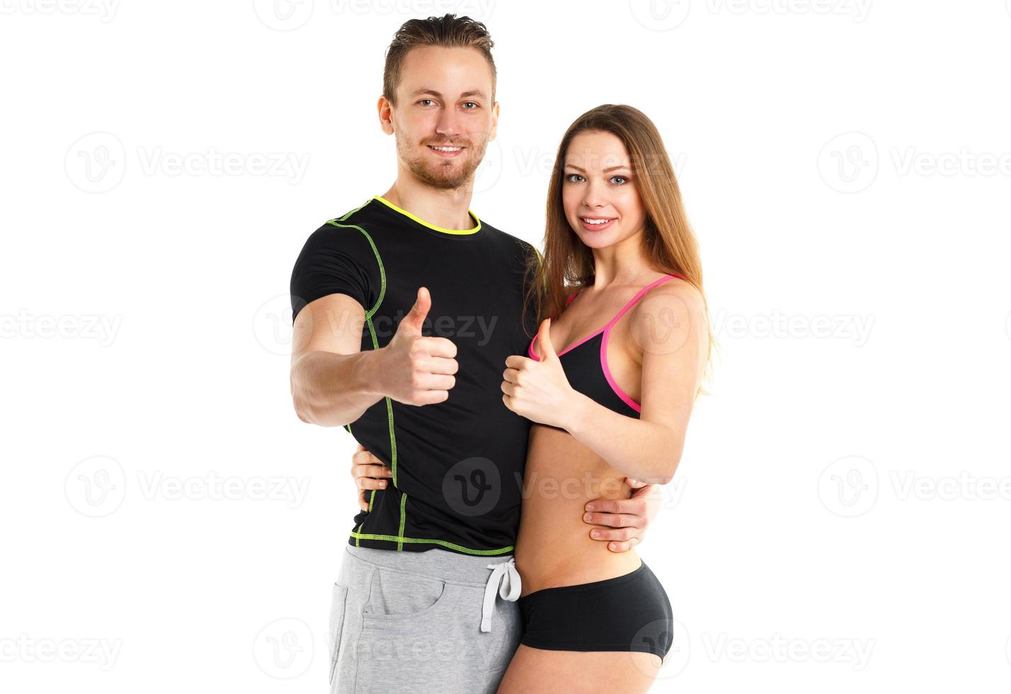 Athletic man and woman after fitness exercise with thumb up on the white photo
