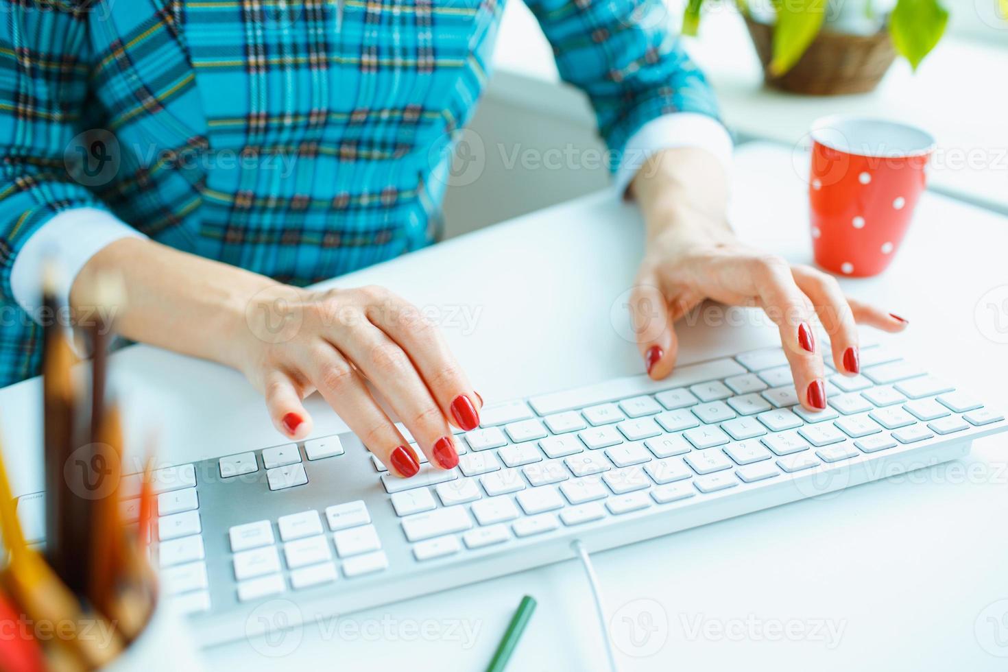 Woman office worker typing on the keyboard photo