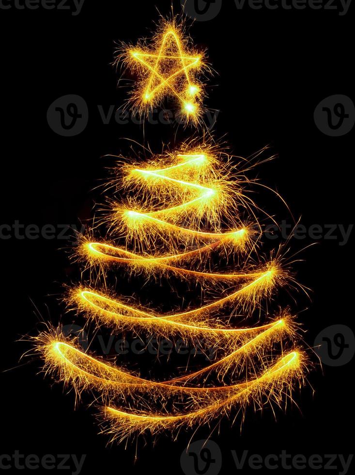 Christmas tree made by sparkler on a black photo