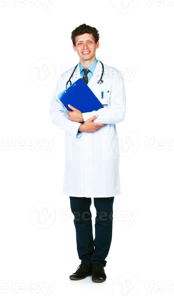 Full length portrait of a smiling male doctor holding a notepad on white photo