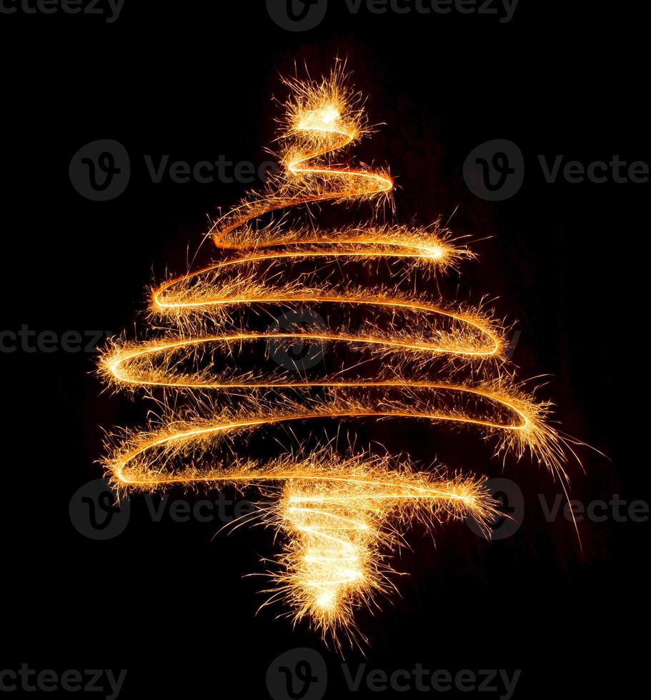 Christmas tree made by sparkler on a black photo