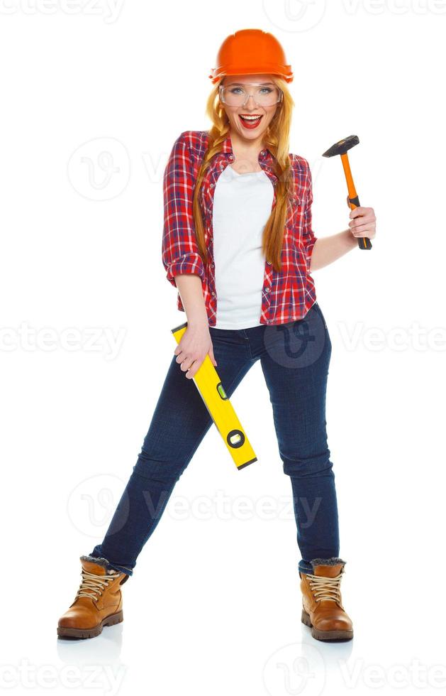 Young woman worker in helmet with the work tools on a white photo