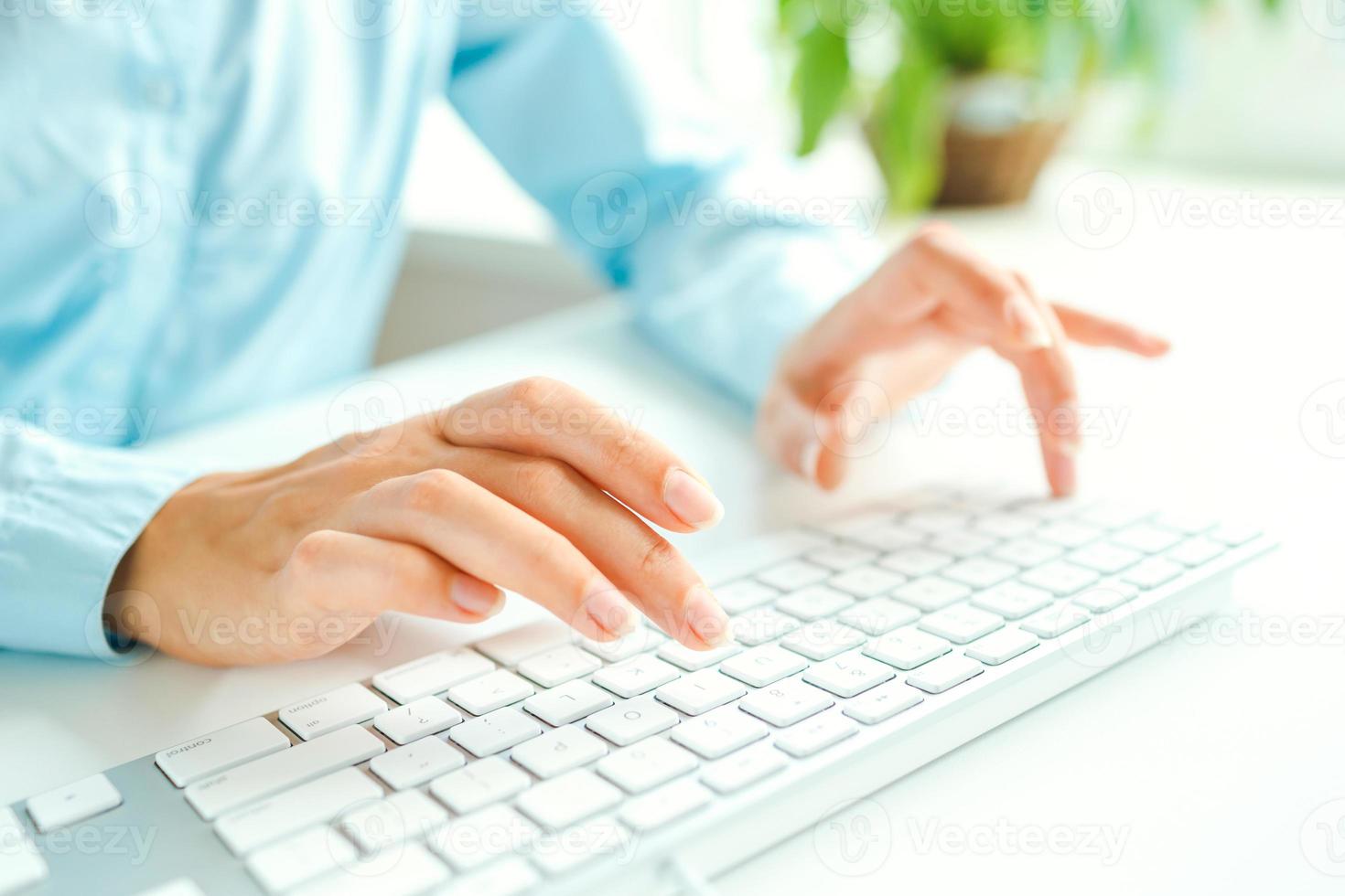 Woman office worker typing on the keyboard photo