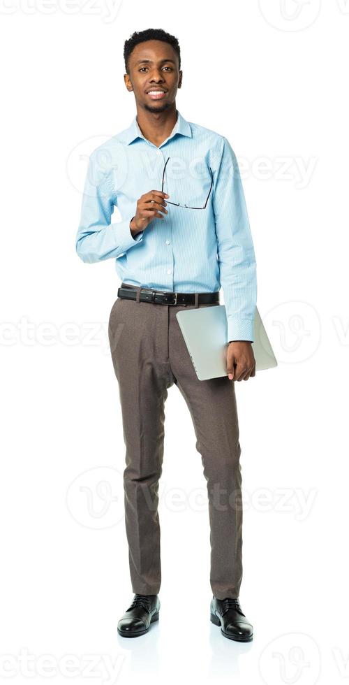 Happy african american college student with laptop standing on white photo