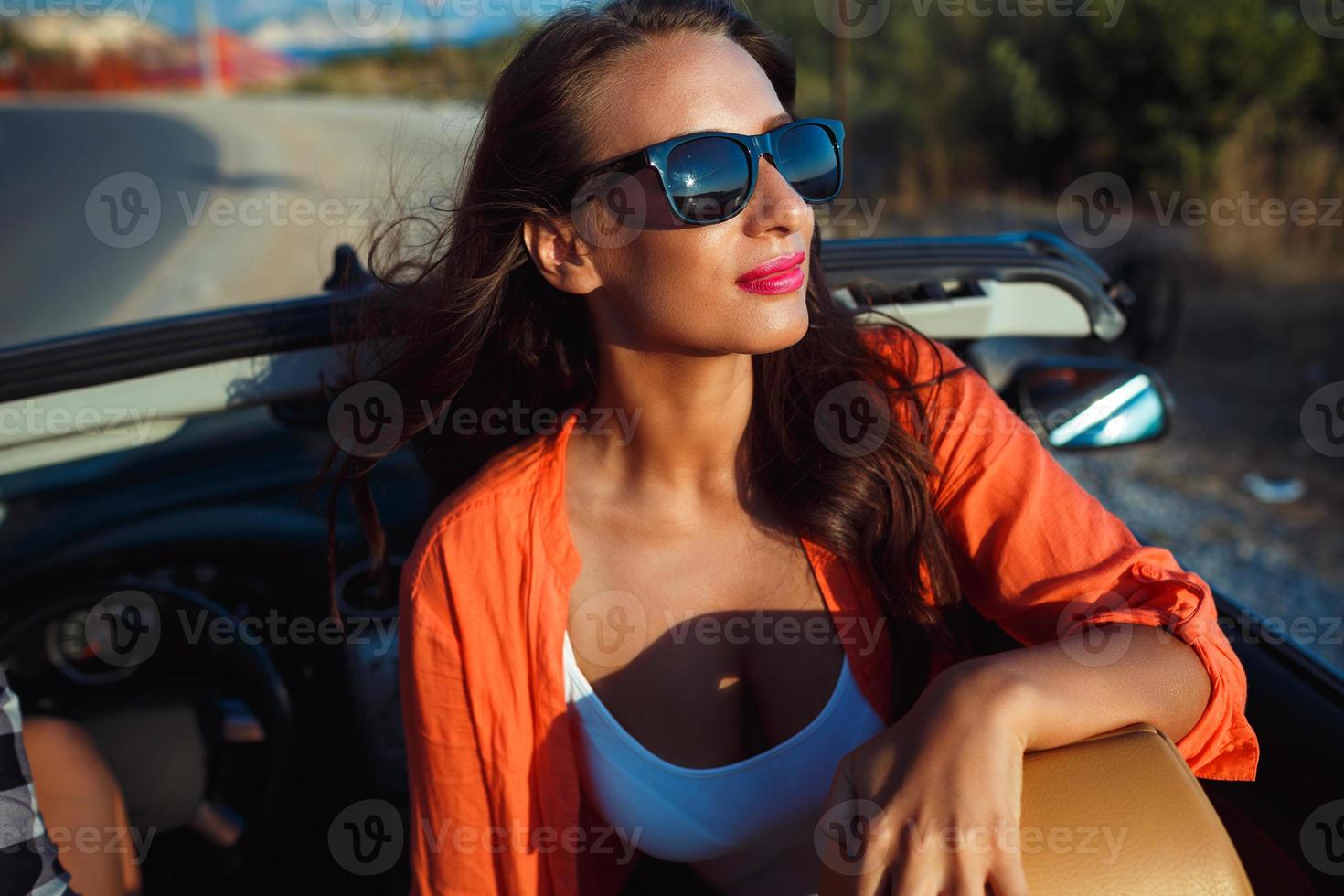 Beautiful woman sitting in cabriolet, fashionable lifestyle concept photo