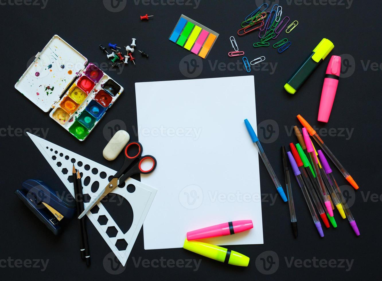 School supplies on blackboard background photo