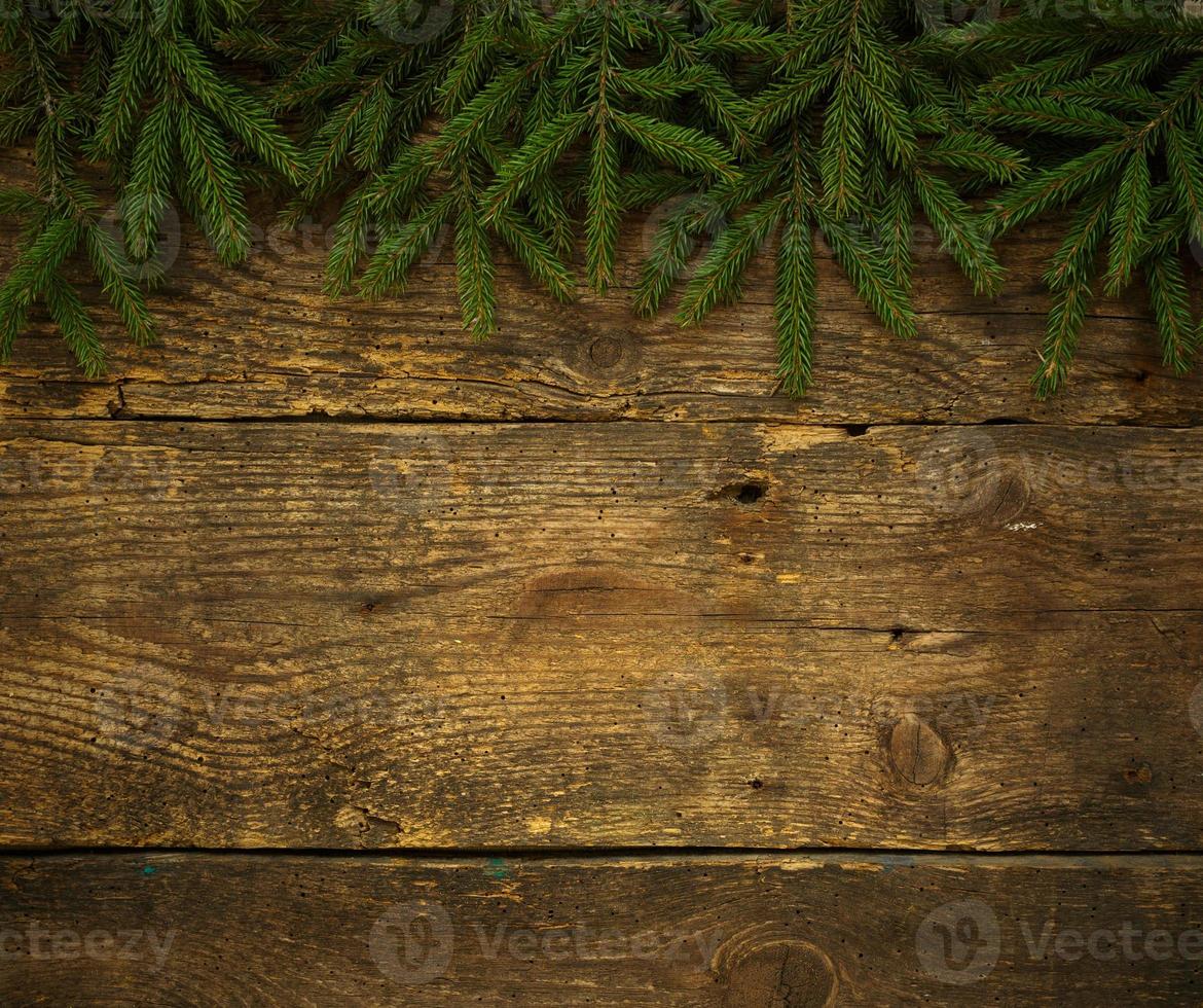 Christmas tree branches on wooden texture ready for your design photo