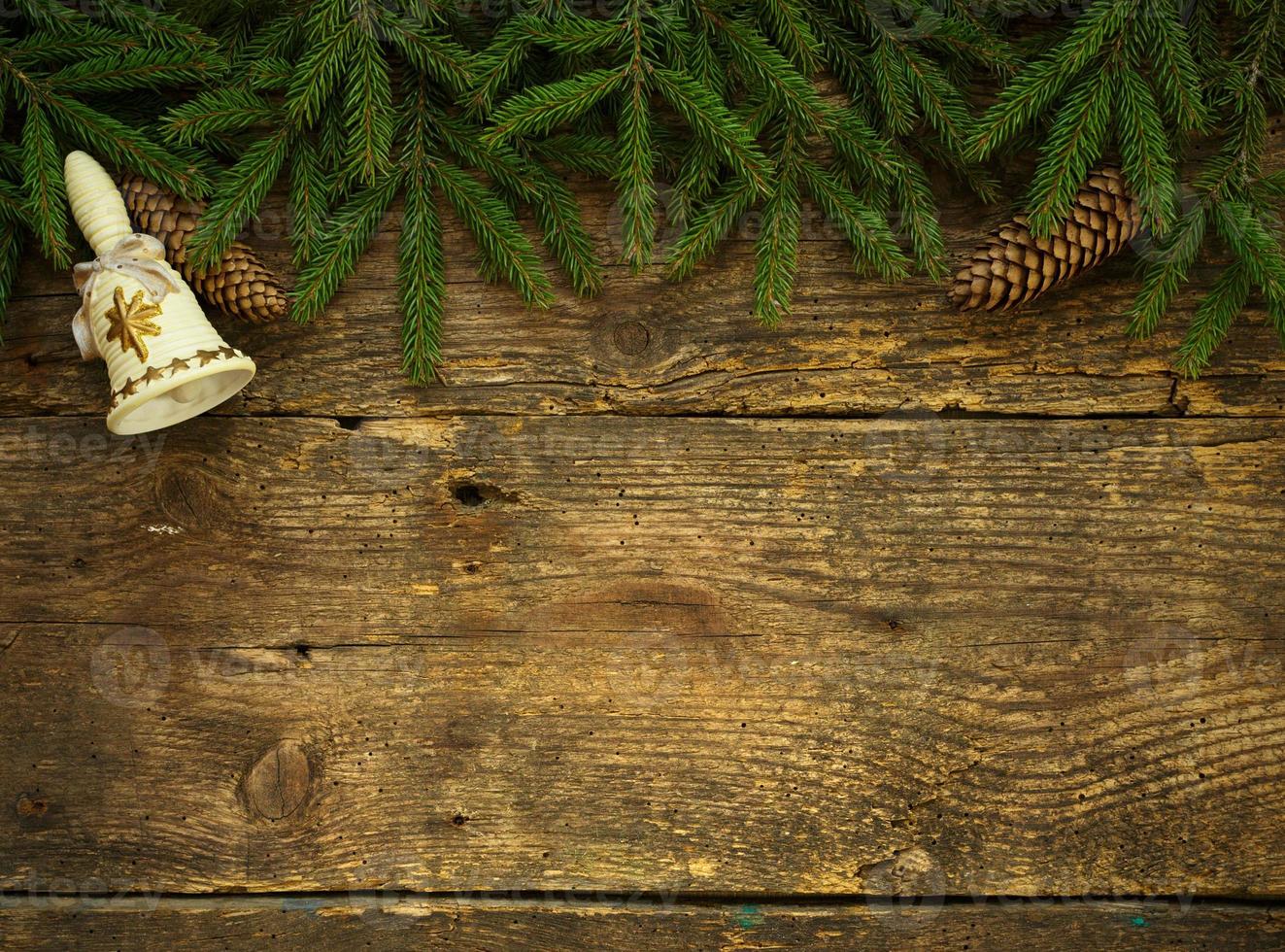 Christmas tree branches with cones and christmas decorations on wooden texture ready for your design photo