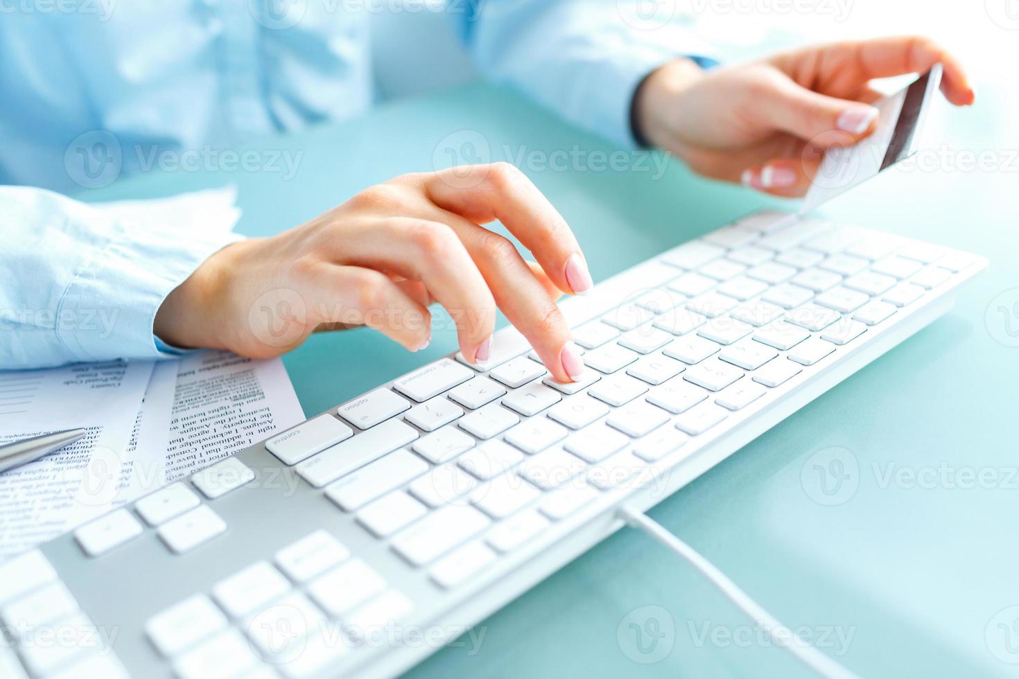 Hands using computer and credit card photo