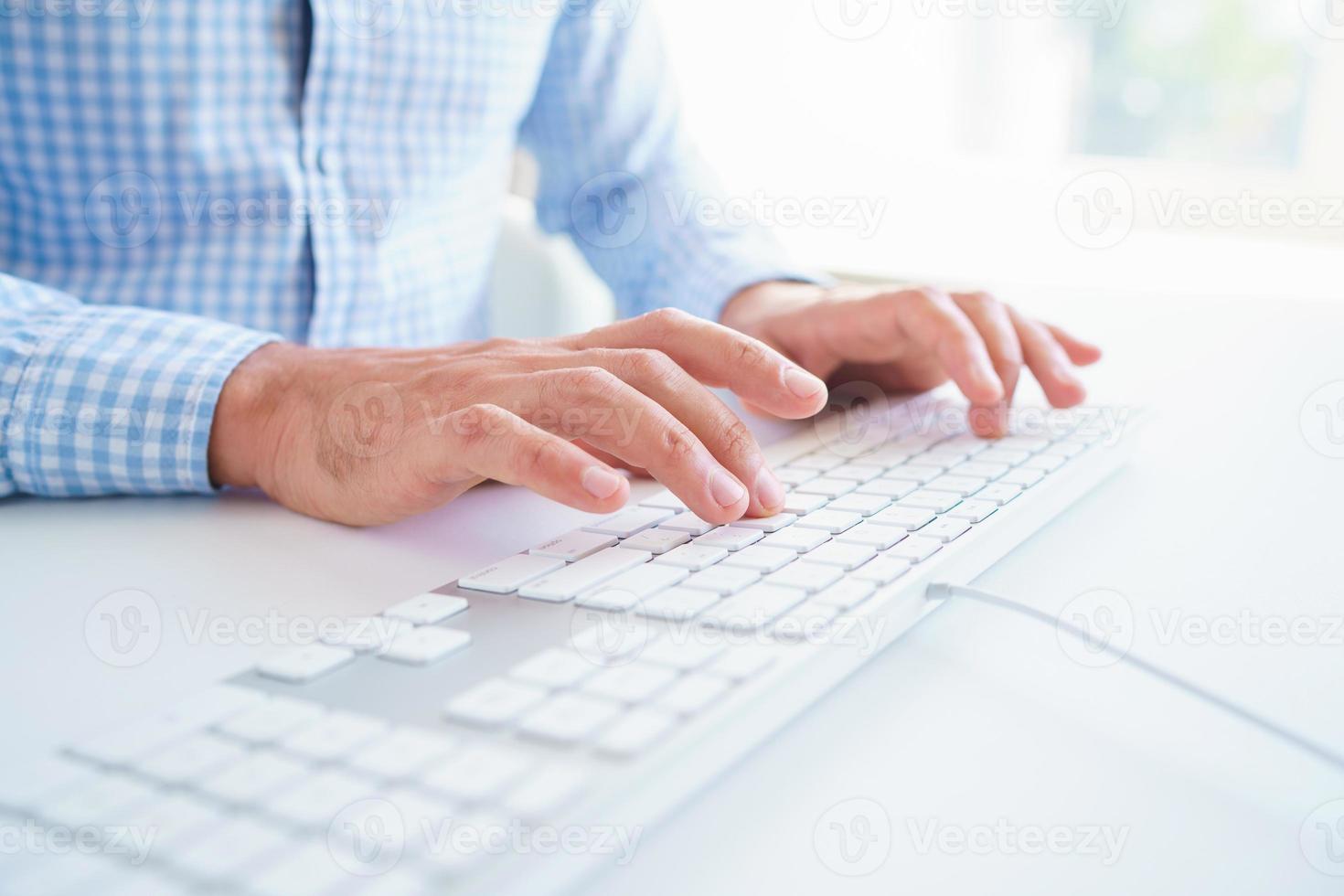 Men office worker typing on the keyboard photo