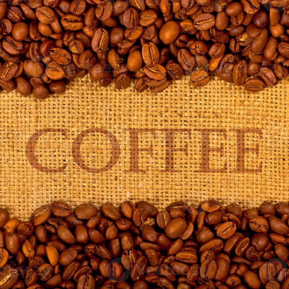 Coffee grains on the burlap background photo