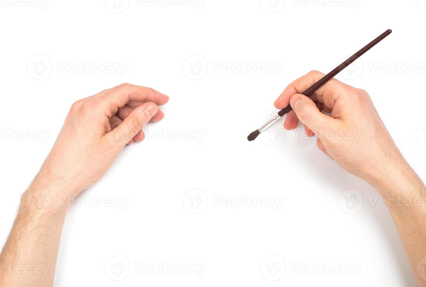 Human hands with brush painting something photo