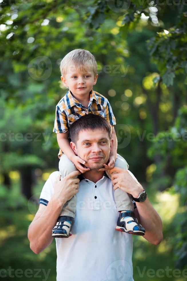 Father and his baby son having fun in the park outdoor photo