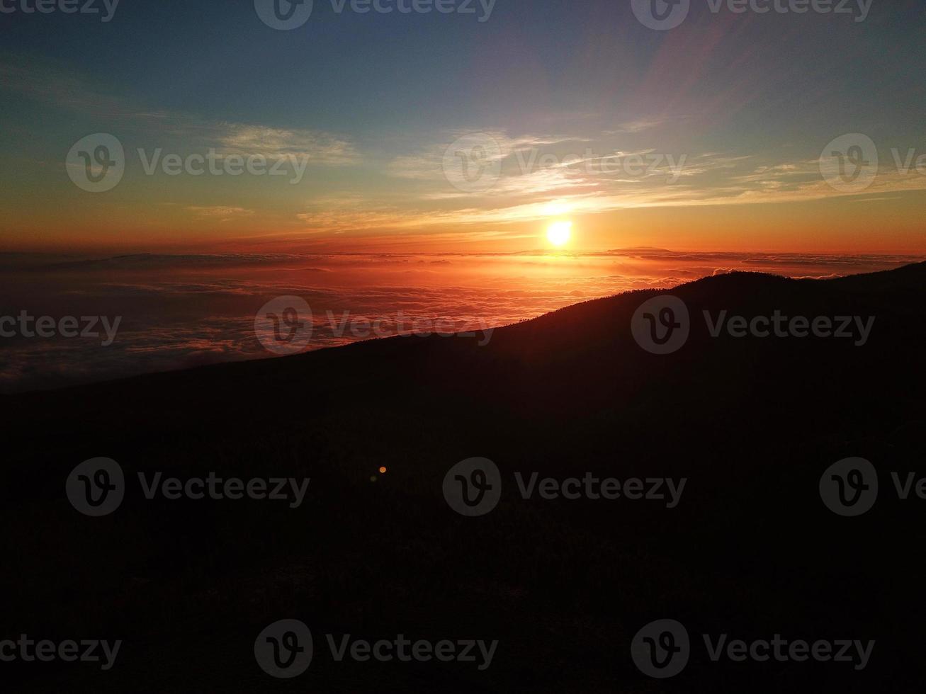 Sunset in the Teide National Park overlooking a sea of clouds under your feet. Tenerife, Canary Islands photo