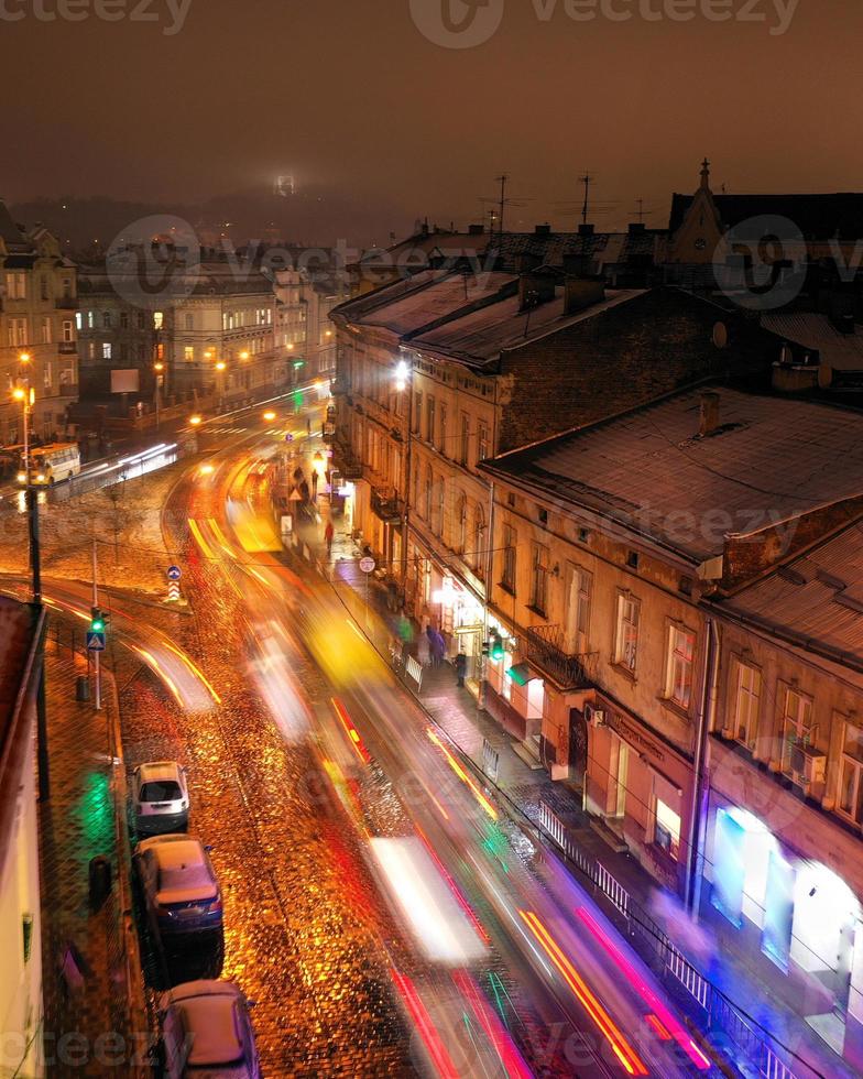 Aerial view of one of the central streets of Lviv in evening. Blurred car lights photo