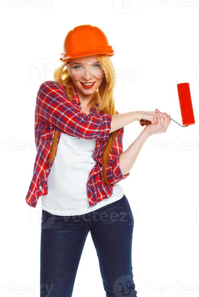 Funny girl in a helmet with roller in hand it is isolated on the white photo