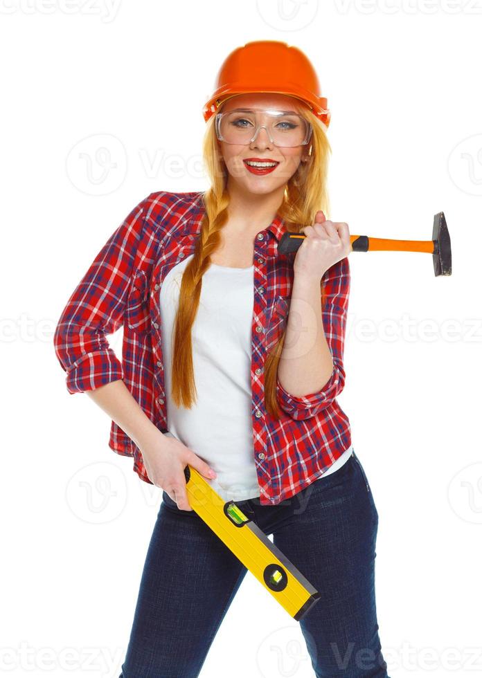 Young woman in helmet with the work tools on a white photo