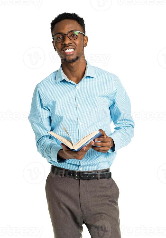 Happy african american college student with books and bottle of water in his hands standing on white photo