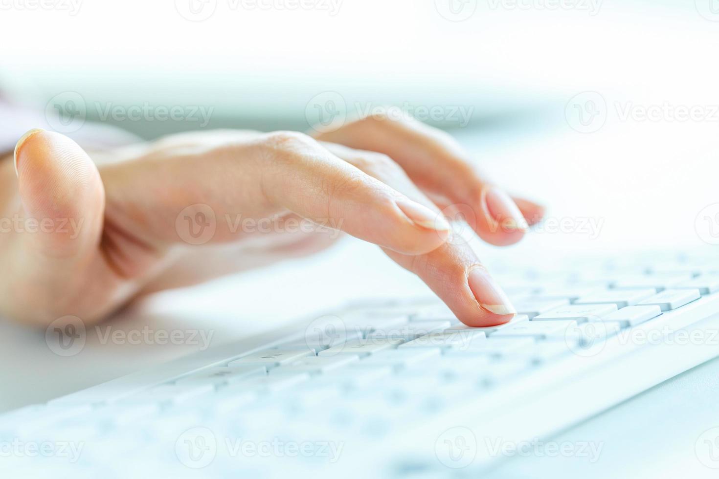 Woman office worker typing on the keyboard photo