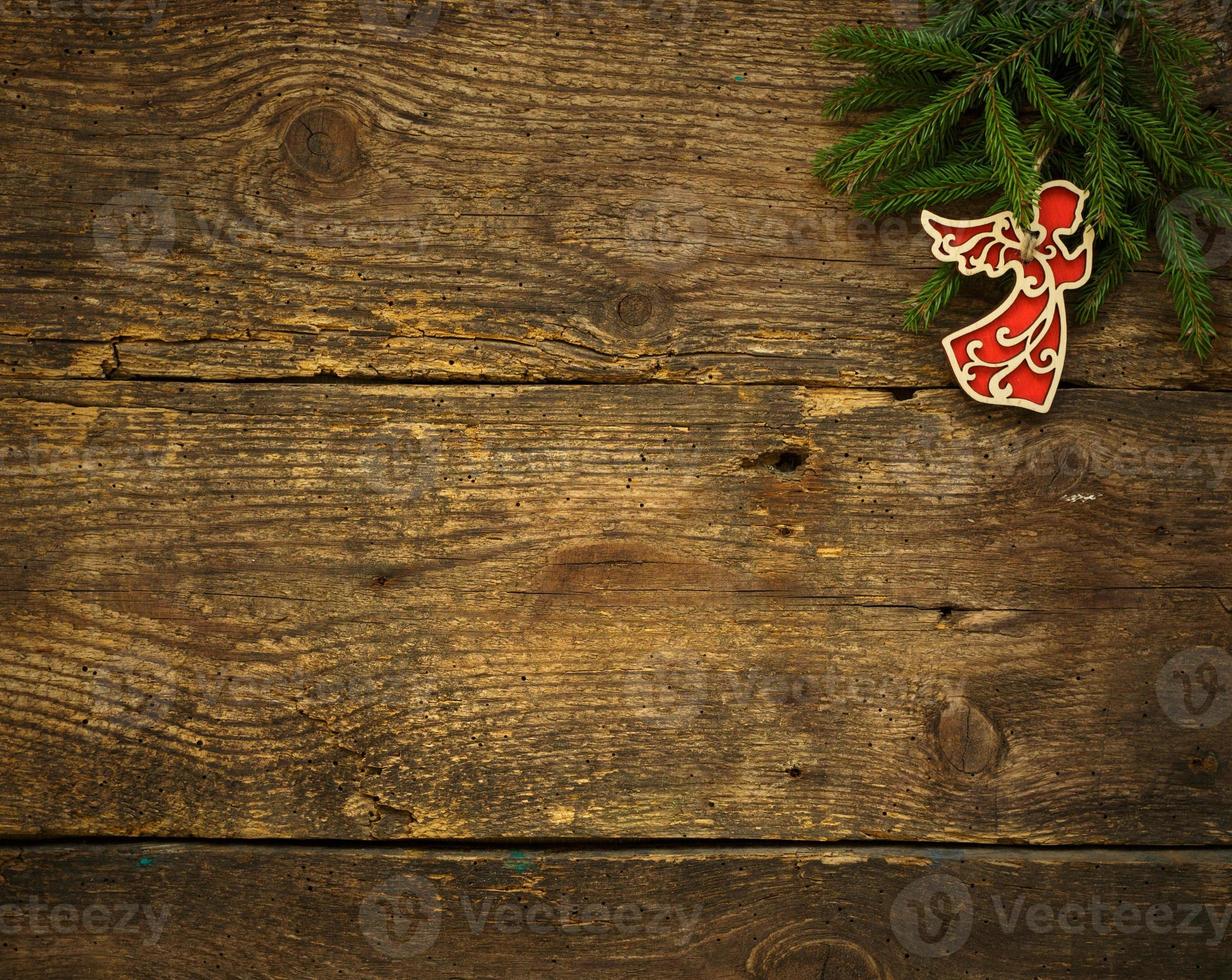 Christmas tree branches with christmas decorations on wooden texture ready for your design photo