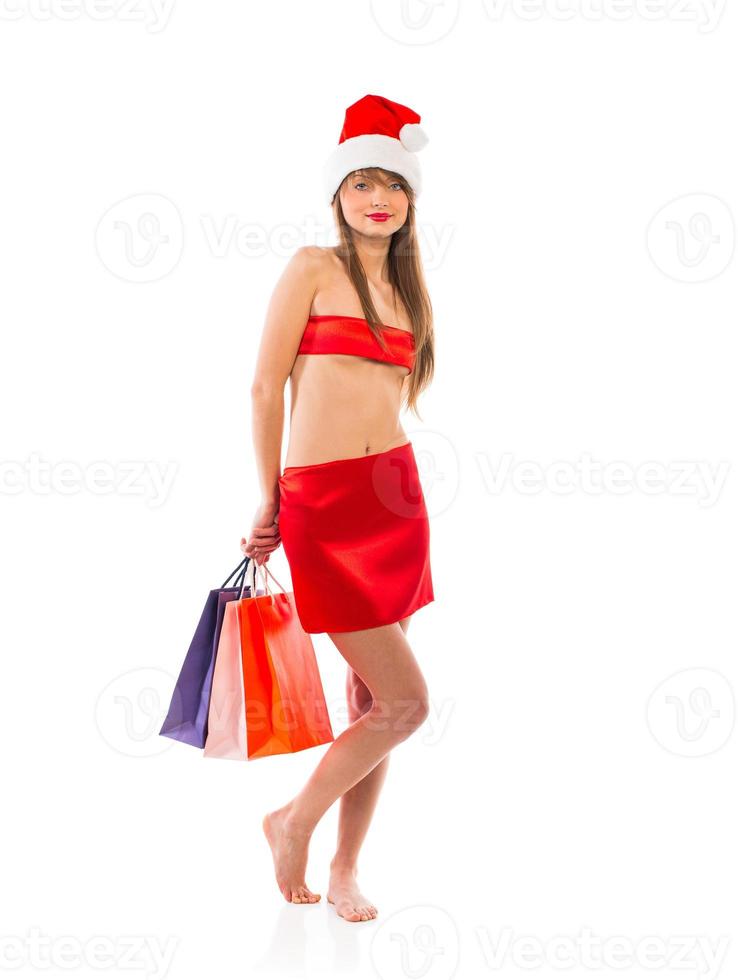 Beautiful Santa christmas girl with shopping bags on white photo