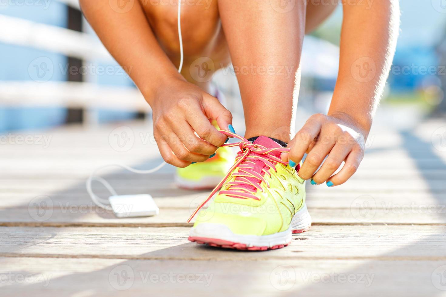 Running shoes - woman tying shoe laces photo