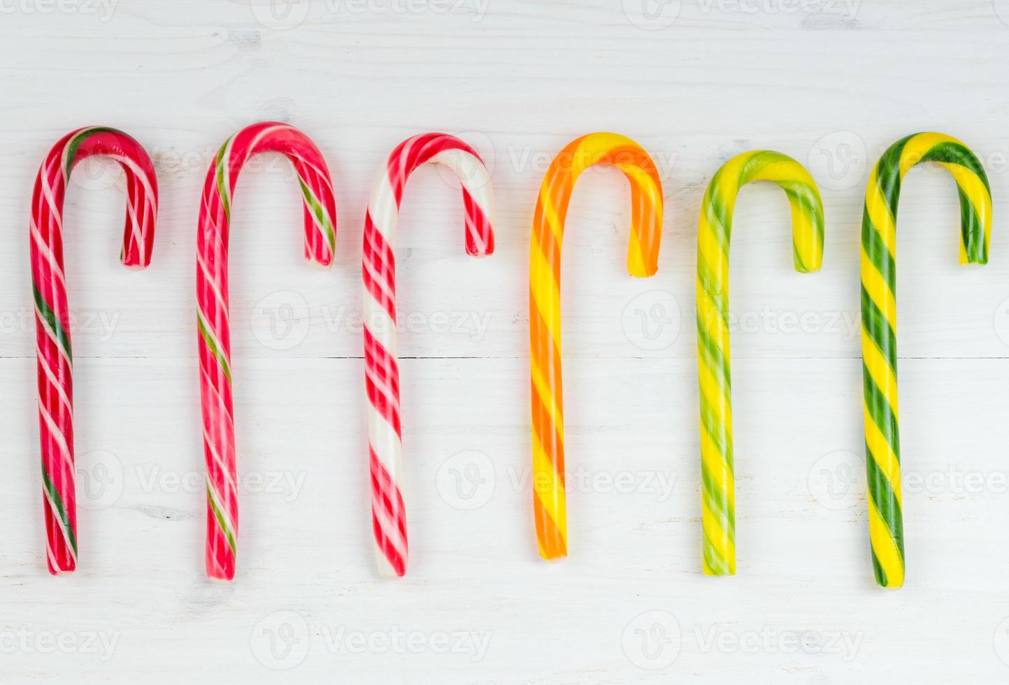 Christmas candy cane on a white wooden background photo