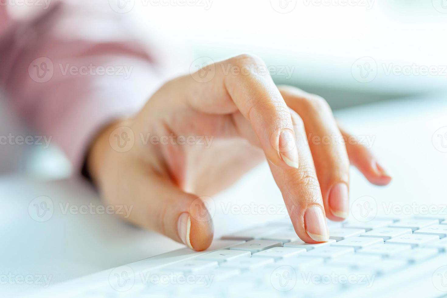 Woman office worker typing on the keyboard photo