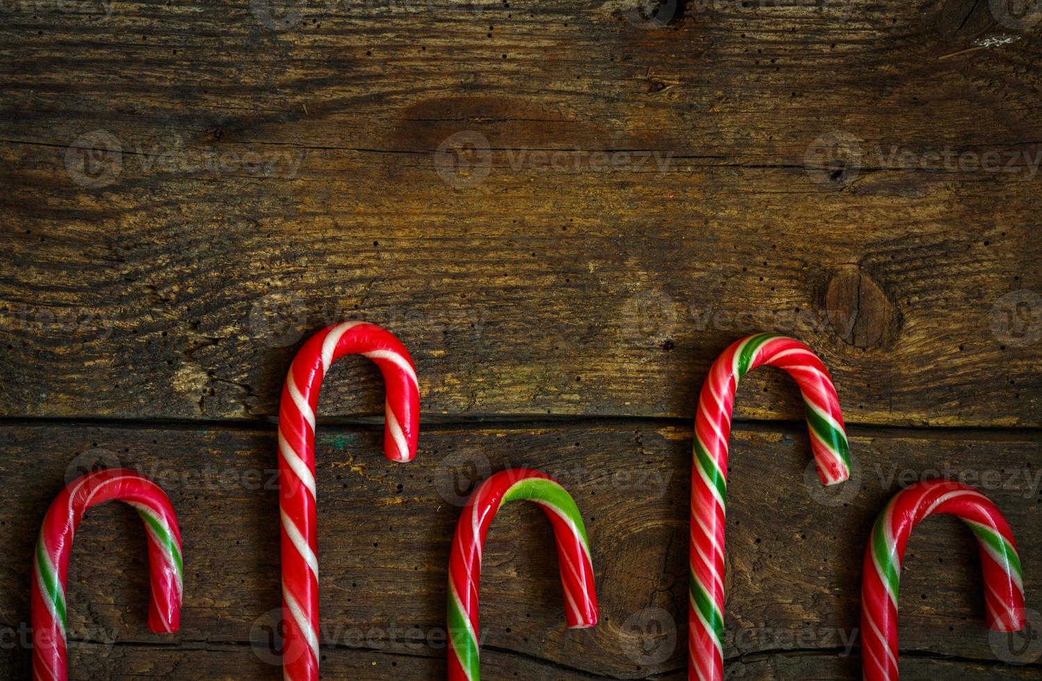 Candy canes on wooden boards photo