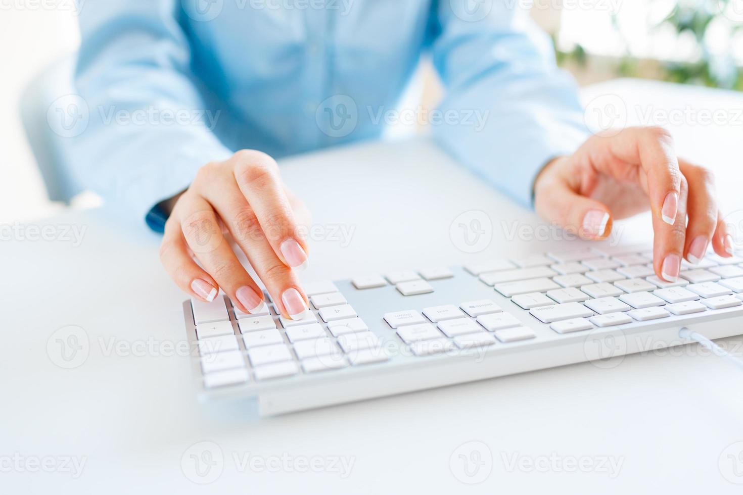 Woman office worker typing on the keyboard photo