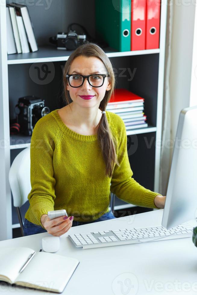 Beautiful young woman working from home photo