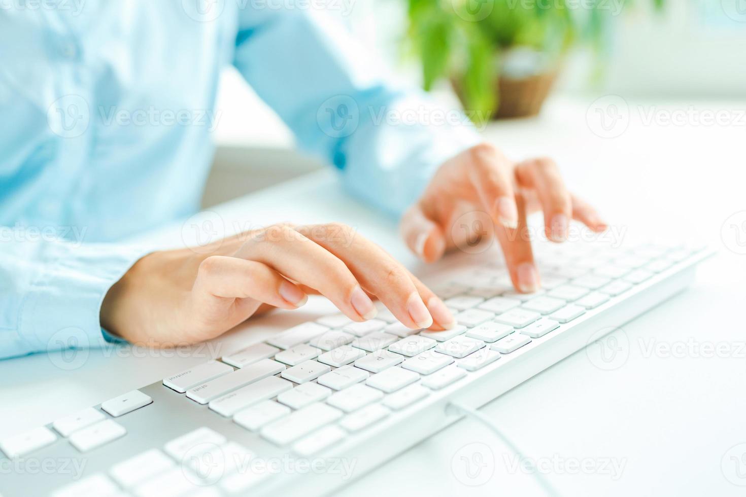 Woman office worker typing on the keyboard photo