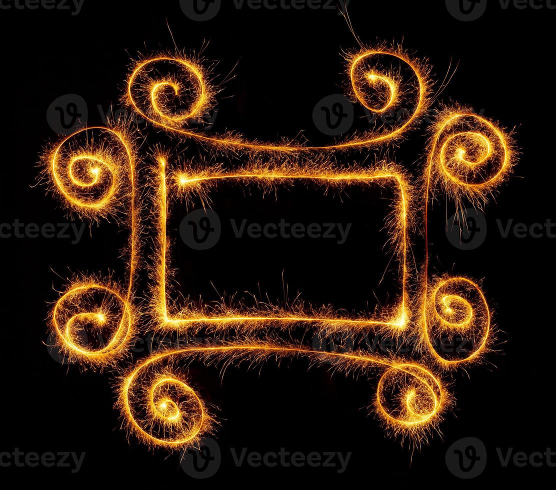 Frame made with sparklers ready for your inscriptions on black photo