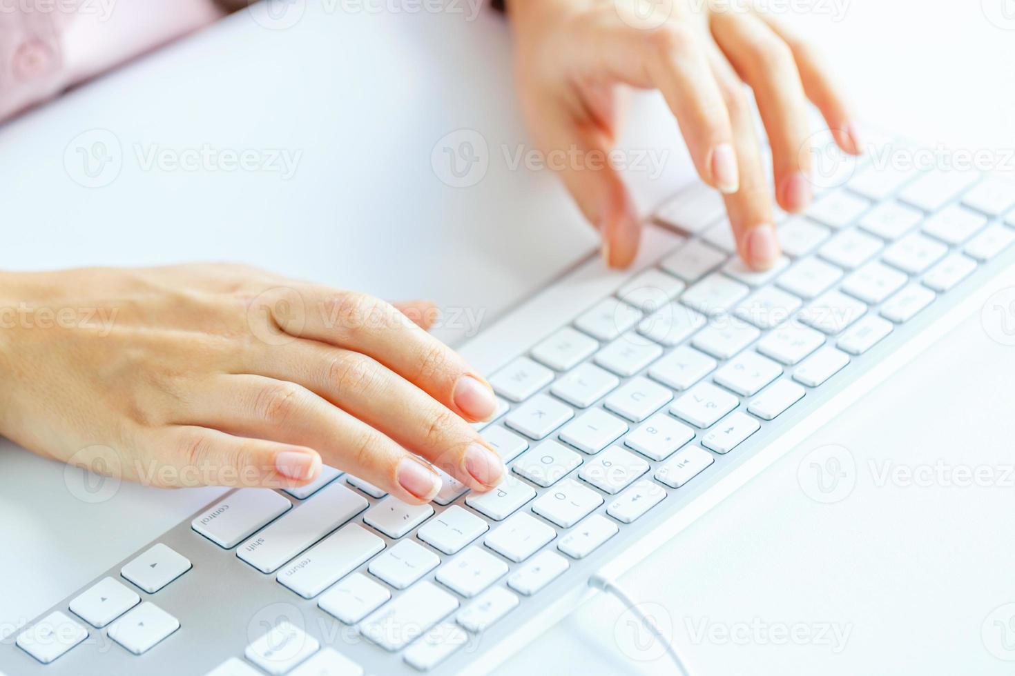 Woman office worker typing on the keyboard photo