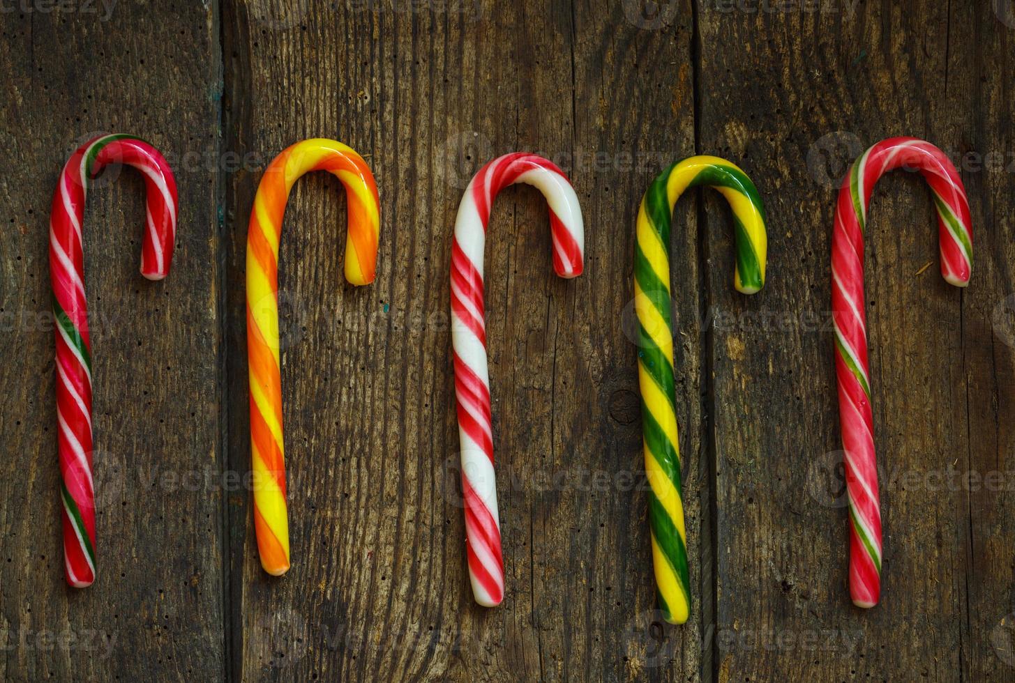 Christmas candy cane on a wooden background photo