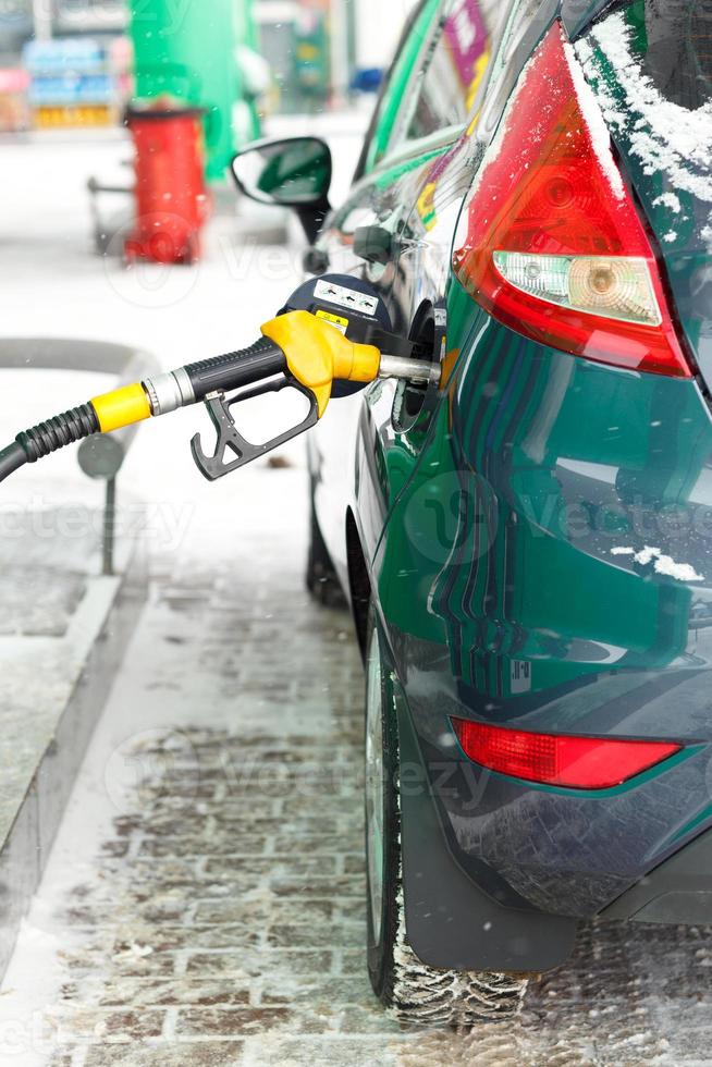 Car refueling on a petrol station in winter photo