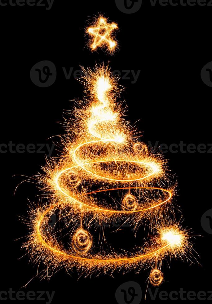 Christmas tree made by sparkler on a black photo