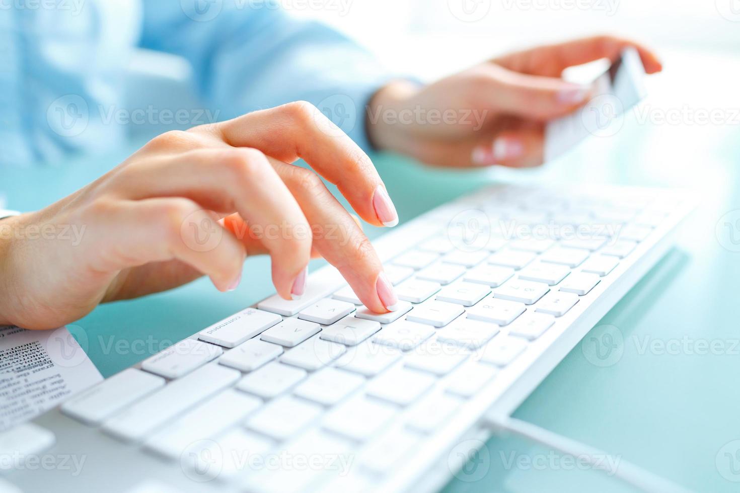 Hands using computer and credit card photo