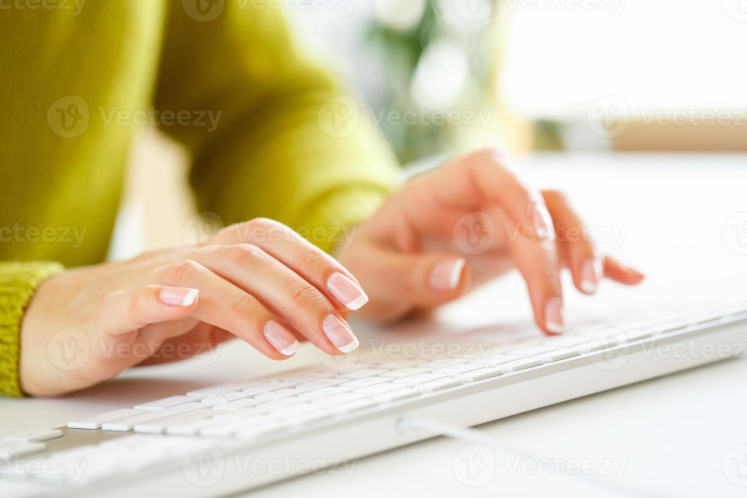 Woman office worker typing on the keyboard photo