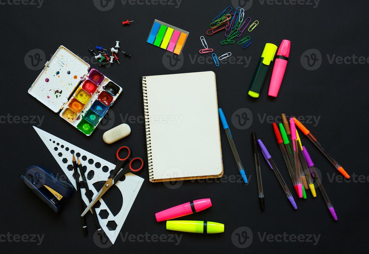 School supplies on blackboard background ready for your design photo