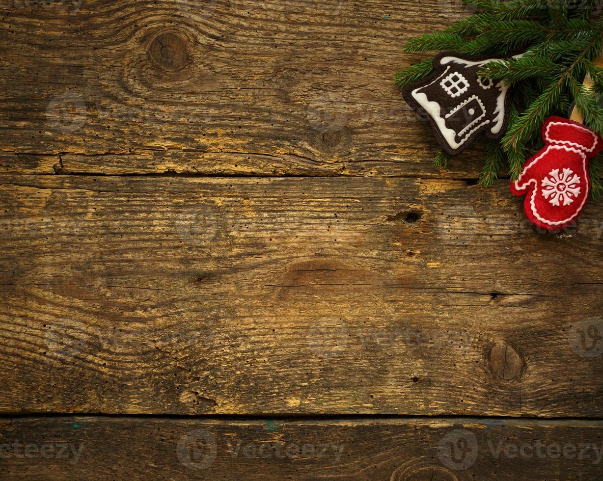 Christmas tree branches with christmas decorations on wooden texture ready for your design photo