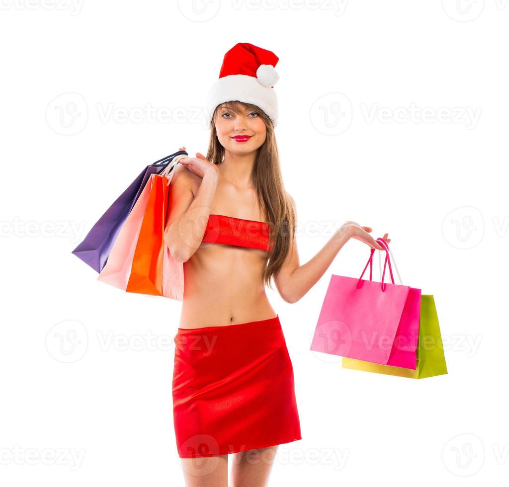 Beautiful Santa christmas girl with shopping bags on white photo