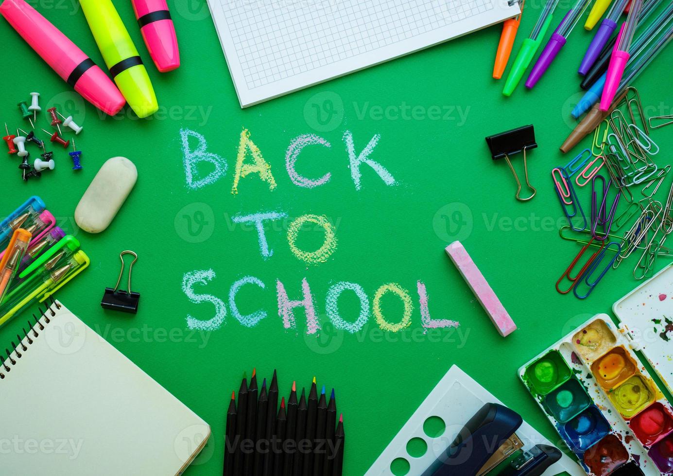 School supplies on blackboard background ready for your design photo